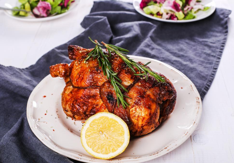 Free Image of Roasted chicken whole, with rosemary and lemon 