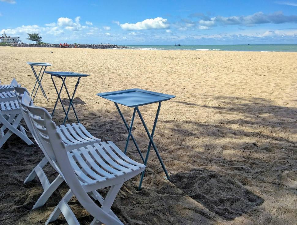 Free Image of Tables and chairs at the beach  