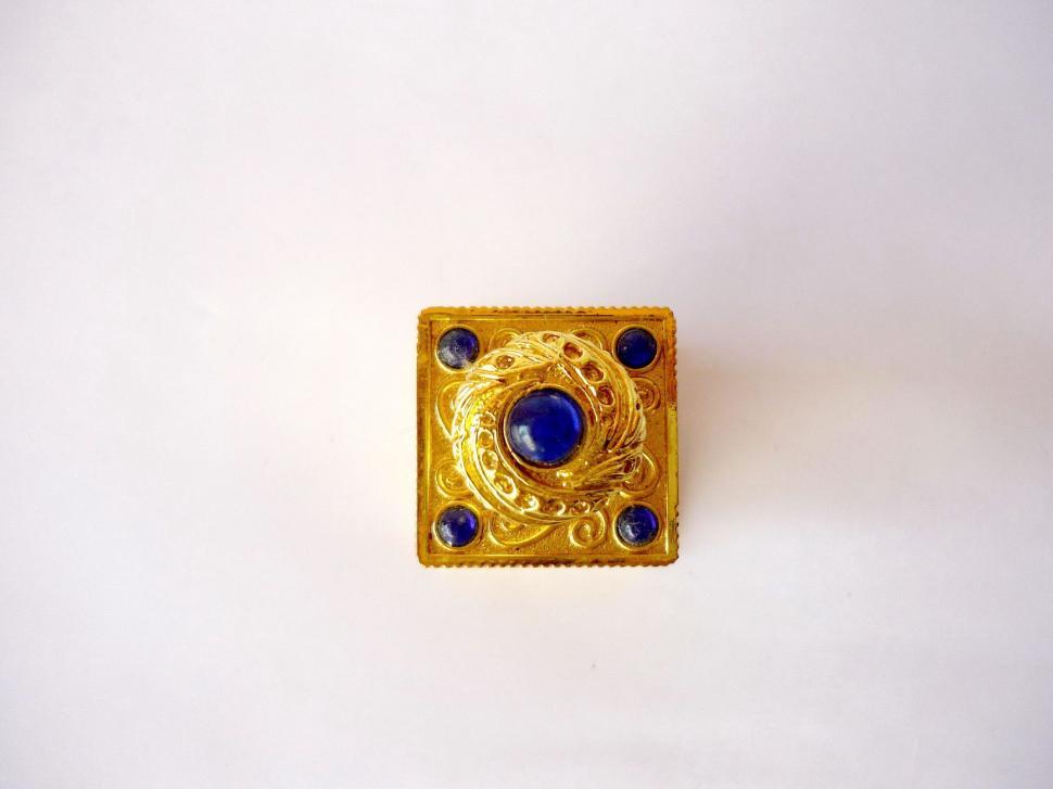 Free Image of Gold Brooch With Blue Stones on White Background 