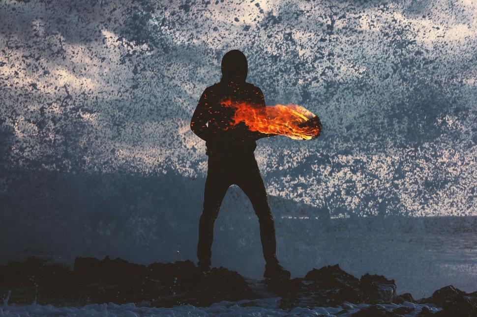 Free Image of Man with fire torch light at the beach 
