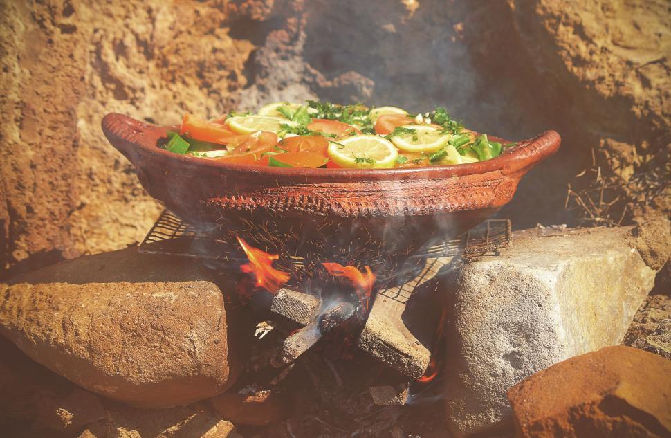 Free Image of Cooking in the clay pot on fire 