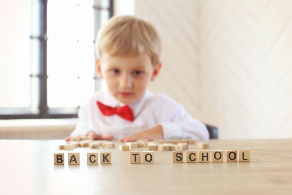 Free Image of Cute boy with Back to School letters 