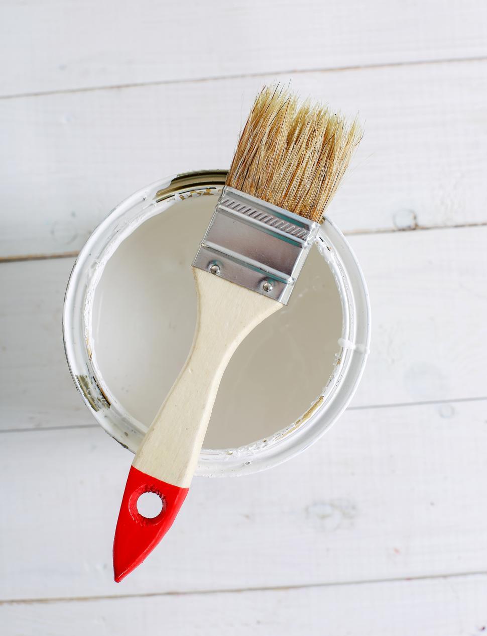 Free Image of Paintbrush on a can of paint 