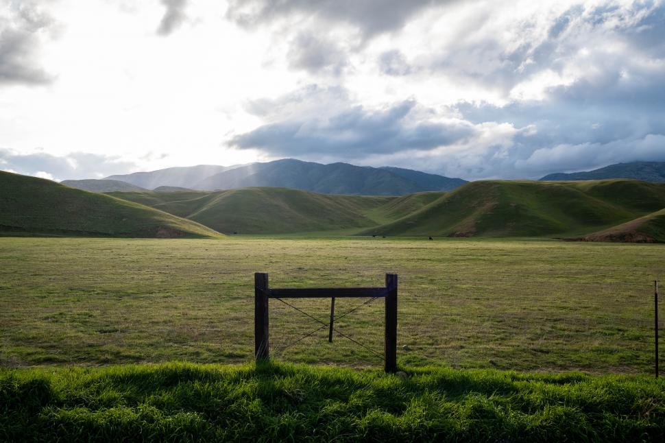 Free Image of Green grass field and mountains 