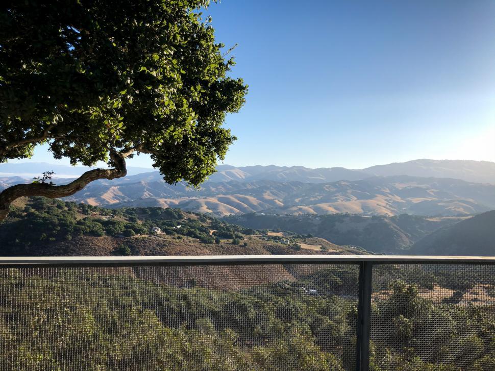 Free Image of Balcony fence with trees and mountains 