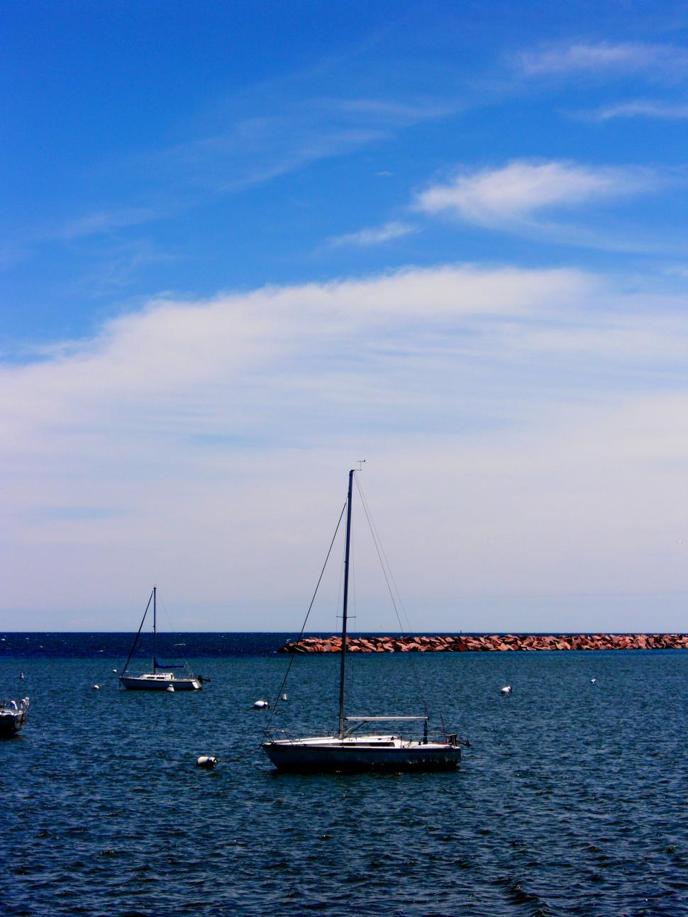 Free Image of Group of Boats Floating on a Large Body of Water 
