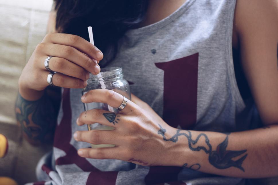 Free Image of Urban woman with finger rings, drinking with mason glass jar and 
