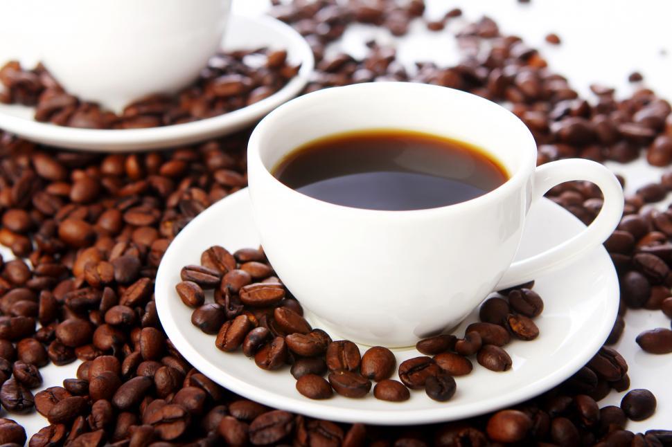 Free Image of Coffee beans with white cups of black coffee 
