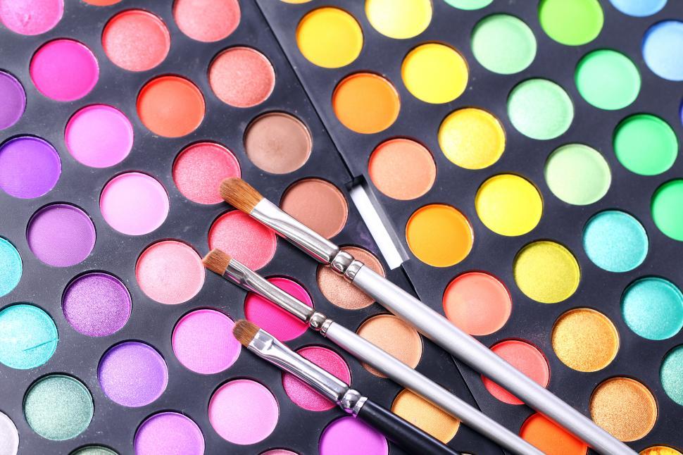 Free Image of Colorful eyeshadows and makeup brushes 