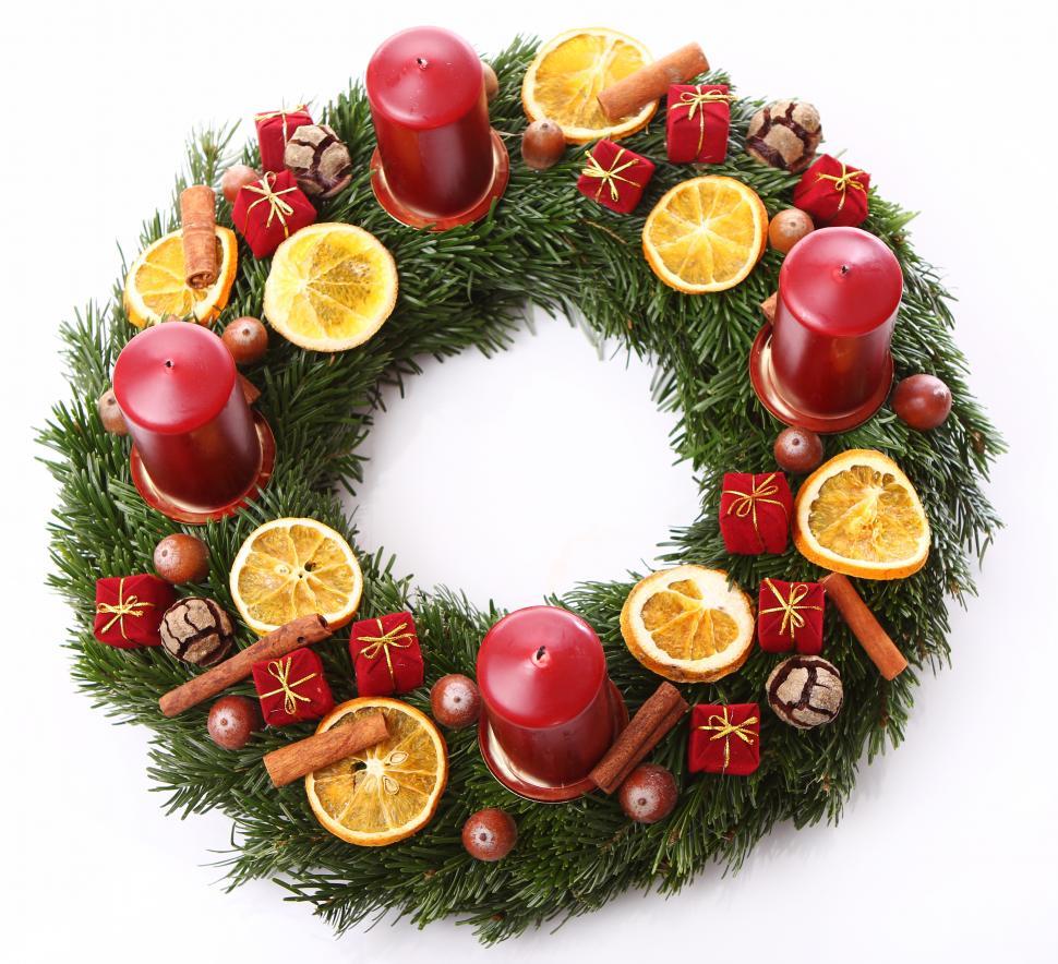 Free Image of Christmas wreath of candles fruit and cinnamon  