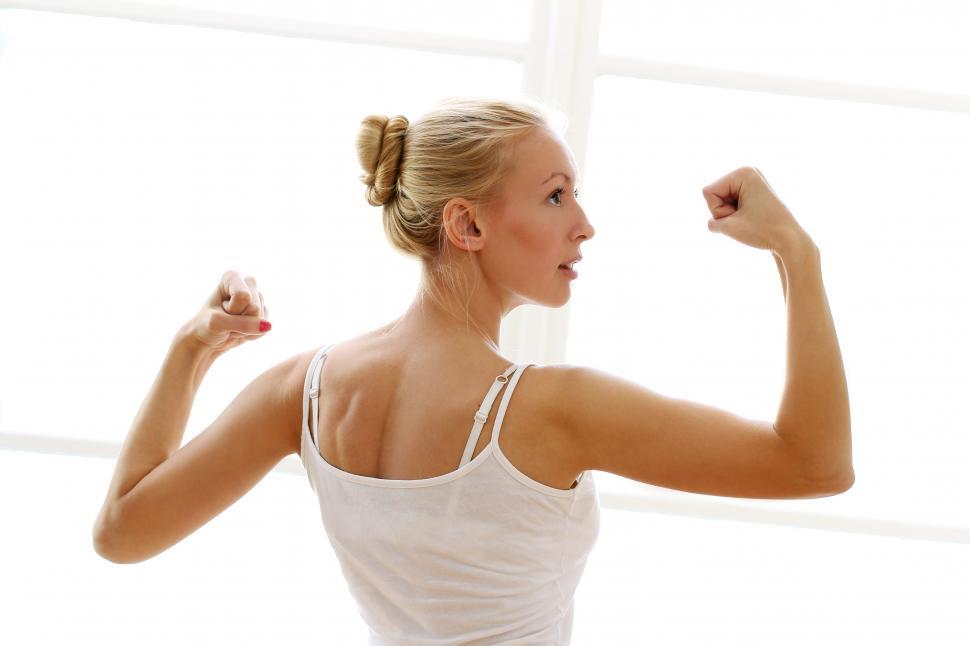 Free Image of Strong woman doing fitness exercises, showing arms 