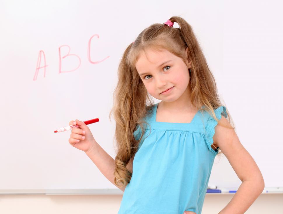 Free Image of Cute little girl writes ABC letters on board 
