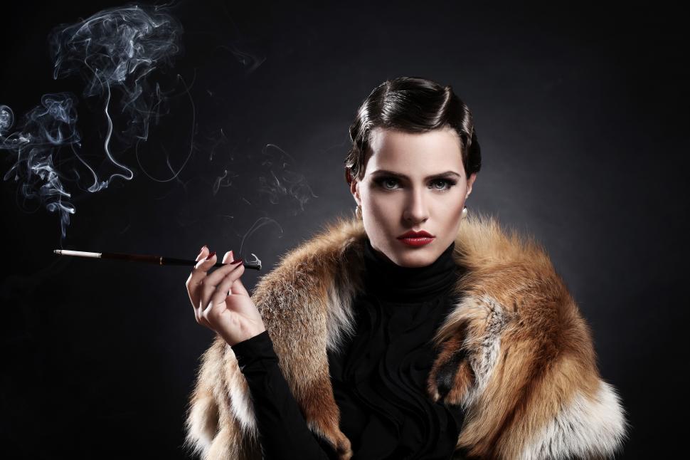 Free Image of Striking woman with cigarette and fur in vintage image 