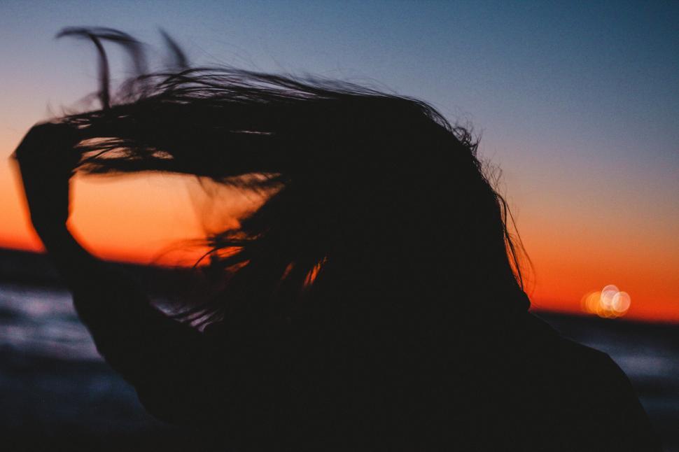 Free Image of Woman hair with ocean and sunset sky 