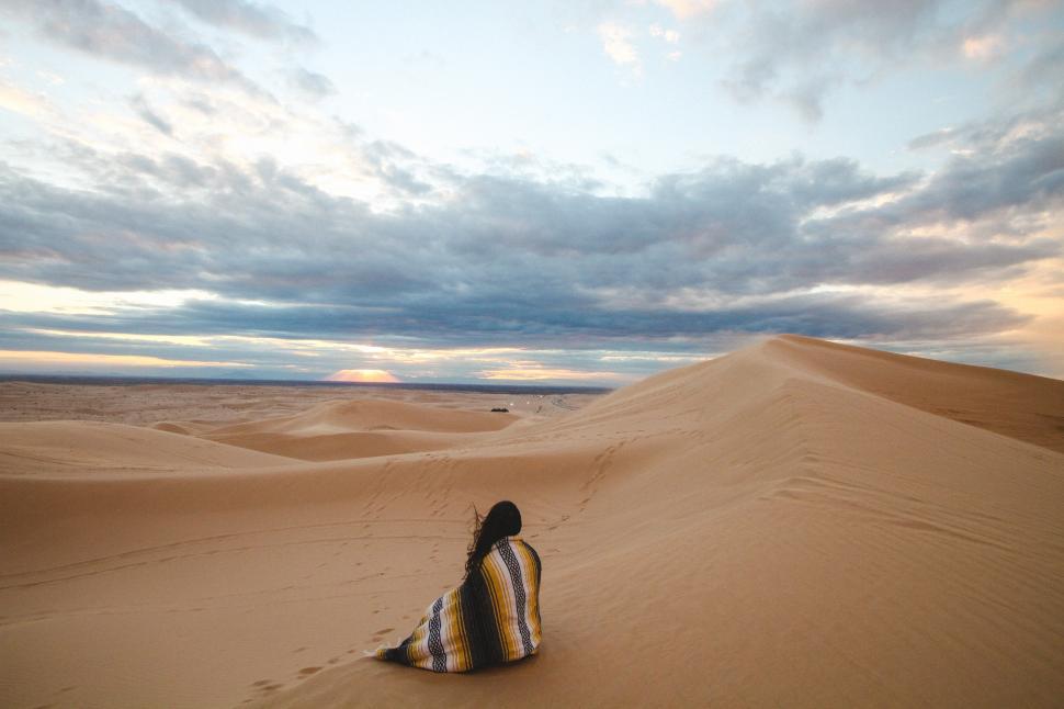 Free Image of Alone woman and desert with sunset clouds 