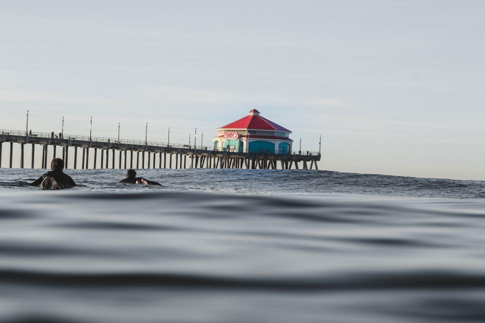 Free Image of Surfers and Ocean with Pier 