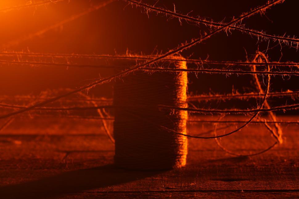 Free Image of Twine strung across area bathed in red light 