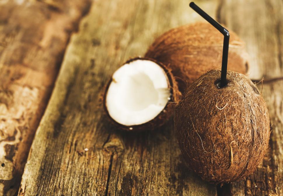 Free Image of Coconut on the table - whole, half and tapped 
