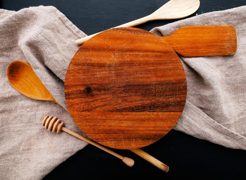 Free Image of Wooden cutting board with wooden utensils 