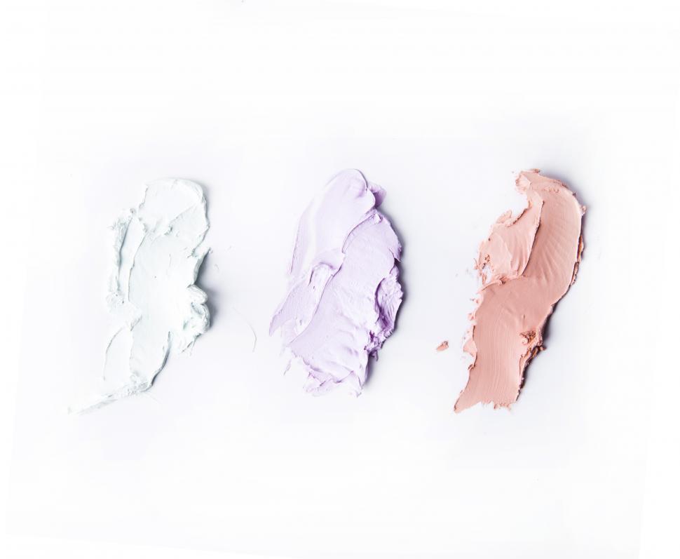 Free Image of Three colors of cosmetics on white background 