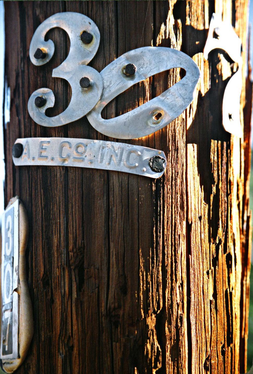 Free Image of Number 307 on wooden pole 