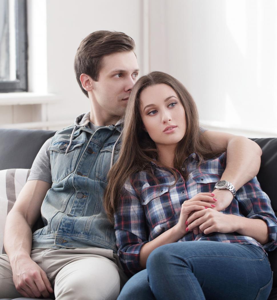 Free Image of Couple sit together on a couch 