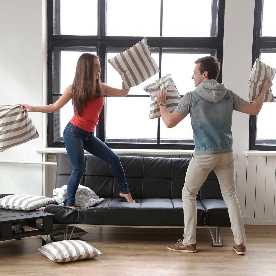 Free Image of Couple having a pillow fight 