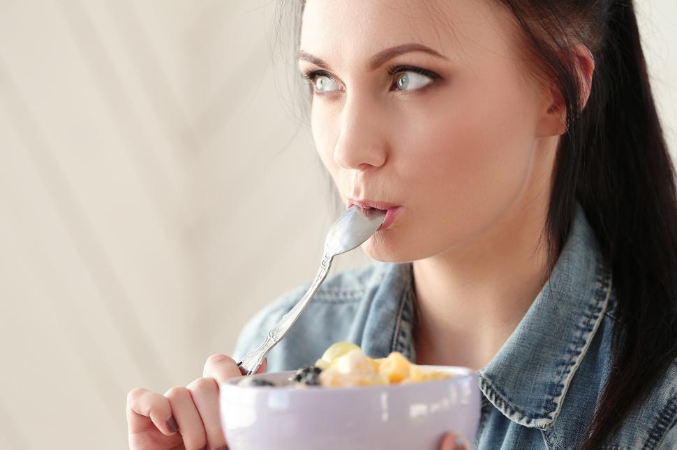 Free Image of Woman licking breakfast spoon 