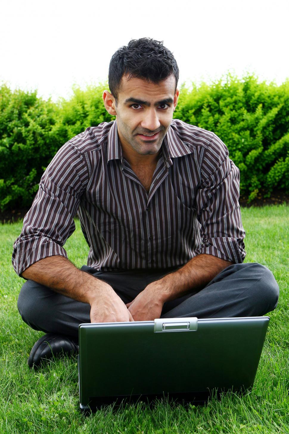 Free Image of Guy on the grass with a laptop 