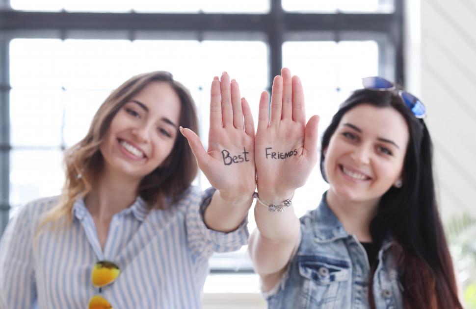 Free Image of Best Friends written on their hands 