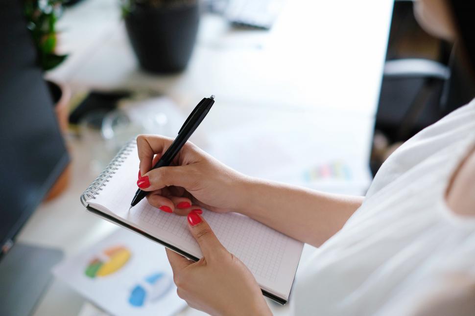 Free Image of Business woman writing in notebook 