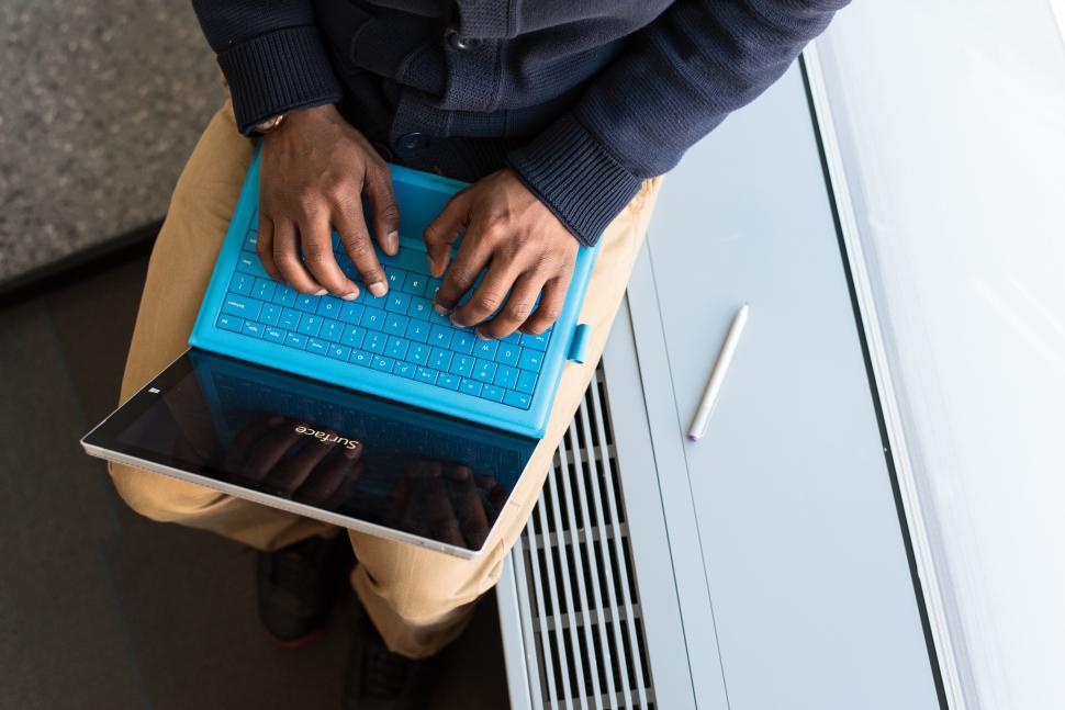 Free Image of Male hands and laptop tablet near window 