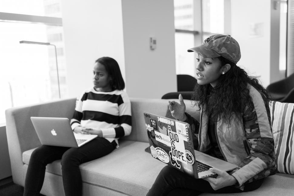 Free Image of Two businesswomen with laptops on couch - b&w 