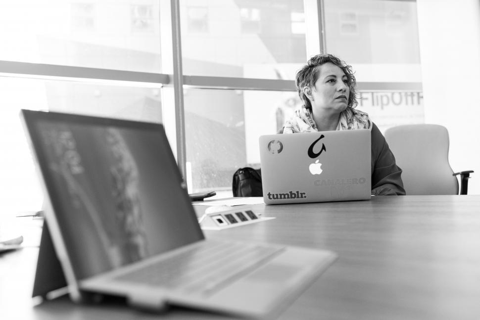 Free Image of Businesswoman with laptop on table in meeting room - b&w 