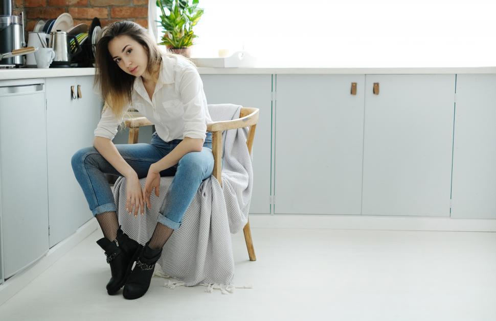 Free Image of Young woman seated at home, with copyspace 