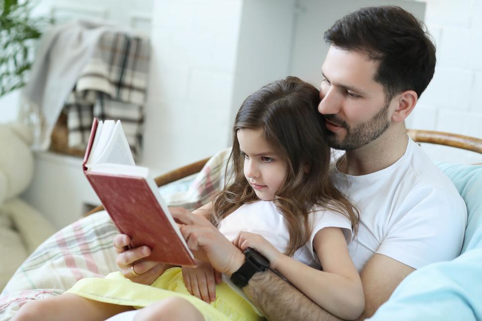 Free Image of Man reading to his daughter 