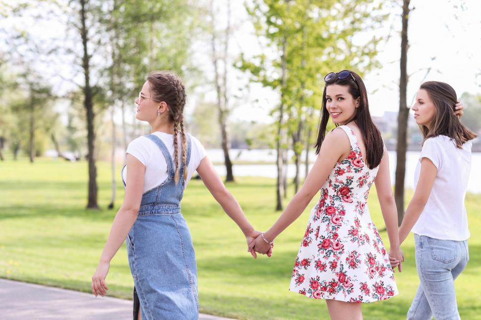 Free Image of Friends holding hands in the park 