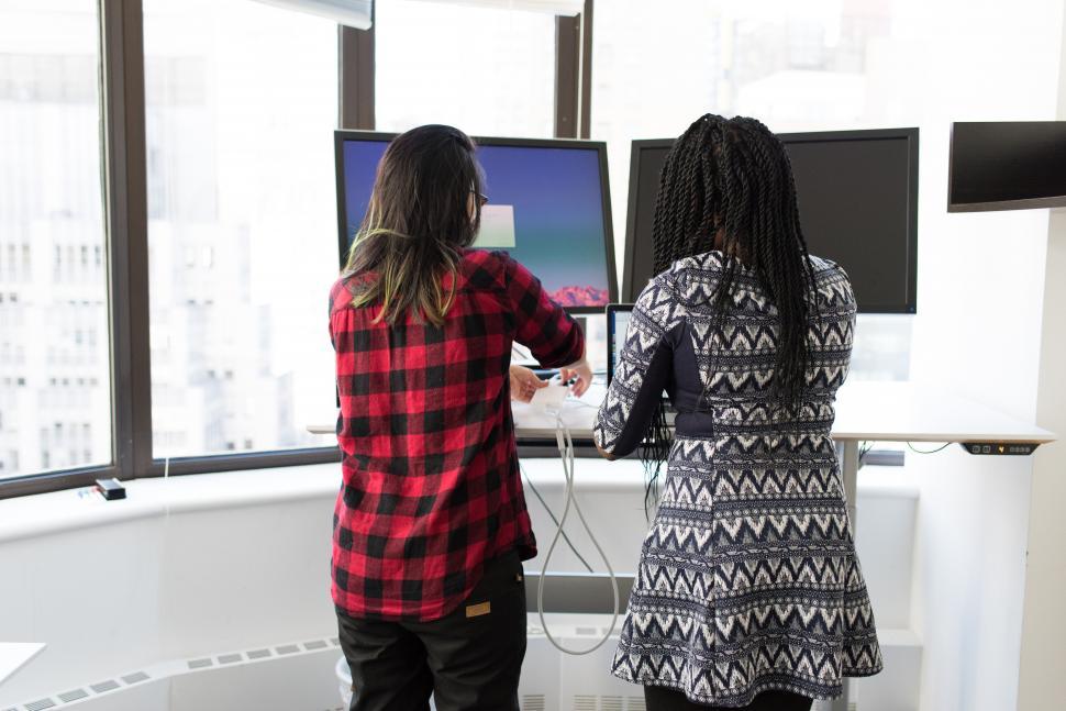 Free Image of Backside view of multi-ethnic female co-workers in office 