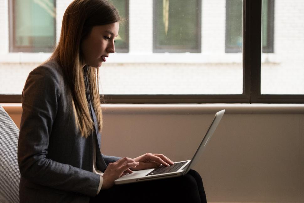 Free Image of Female executive using laptop near window in office 