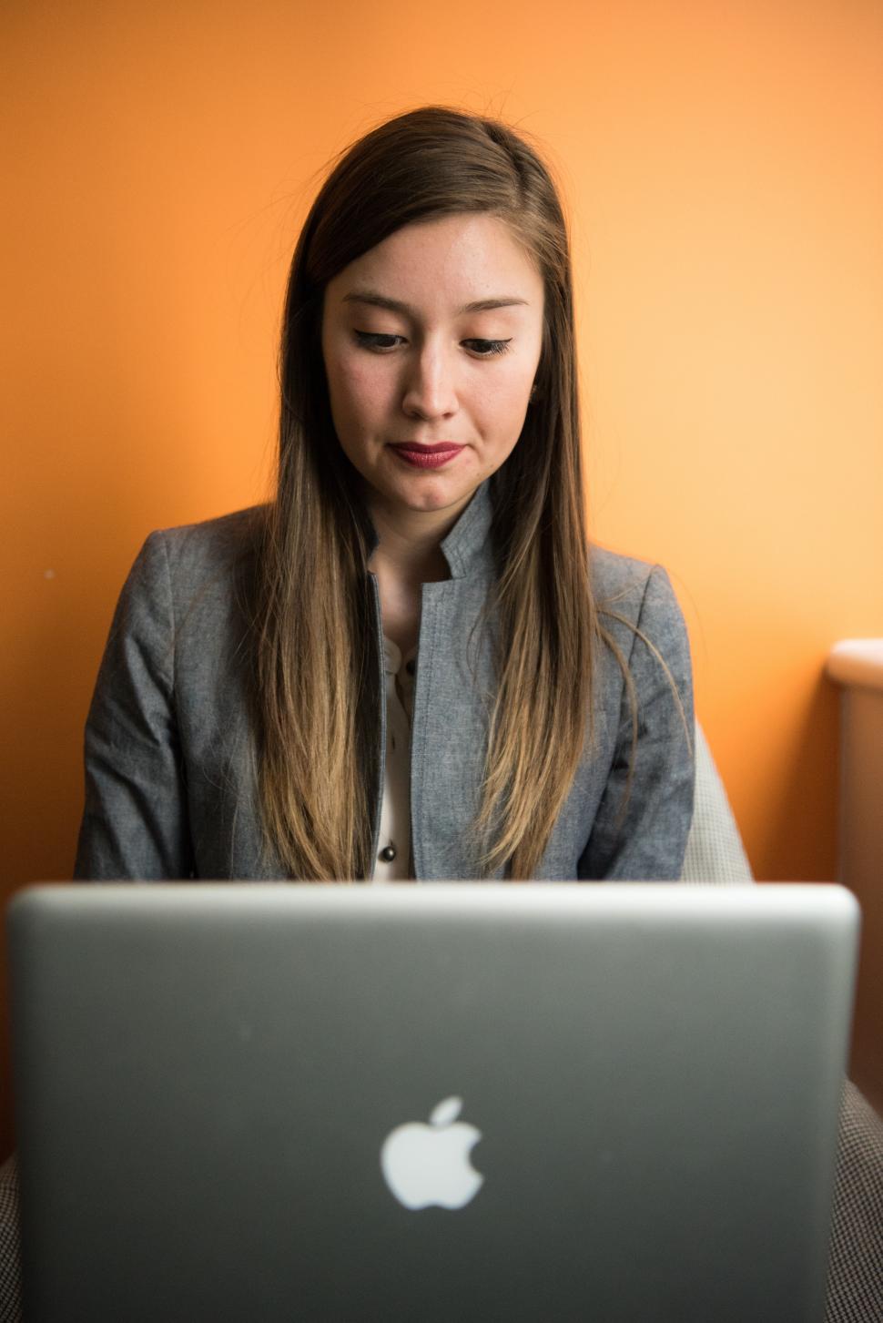 Free Image of Female executive using macbook laptop in office 
