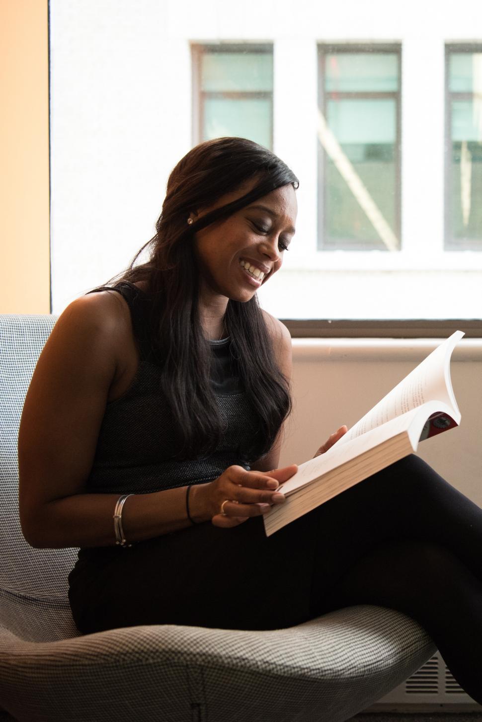 Free Image of Smiling woman with book 