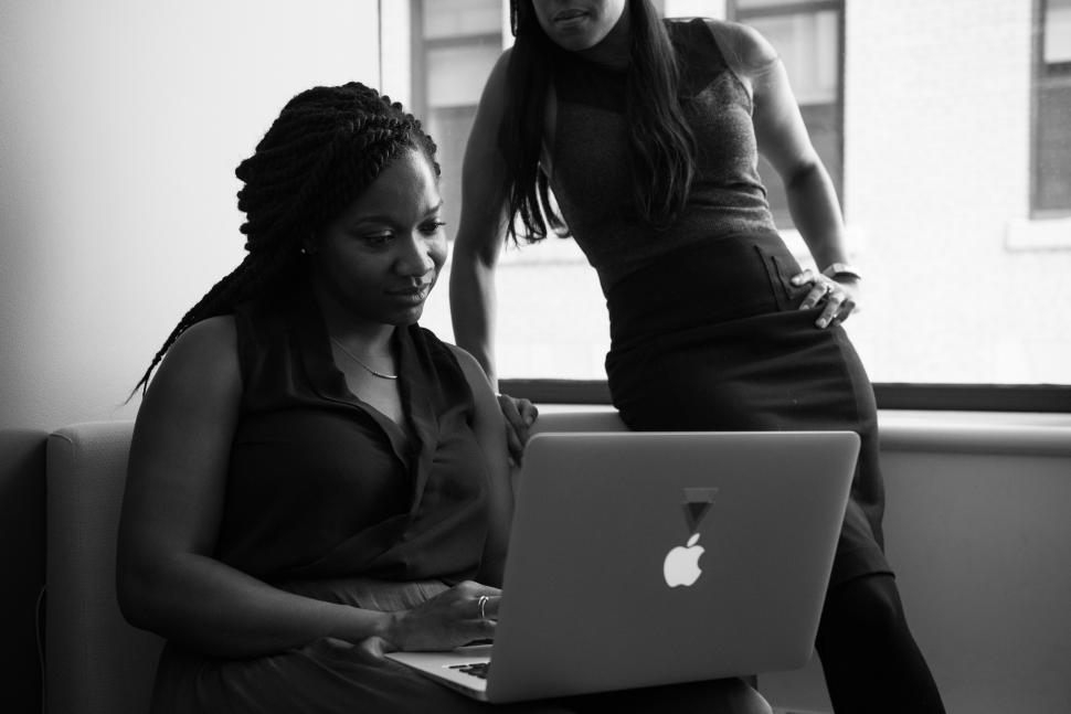 Free Image of Two business women with laptop in office - b&w 