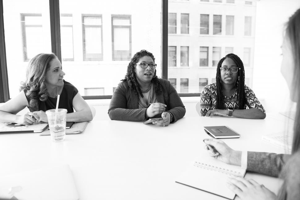 Free Image of Businesswomen having a conversation in meeting room - b&w 