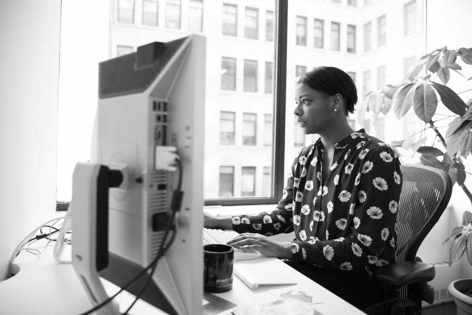 Free Image of Woman using computer at the desk - b&w 