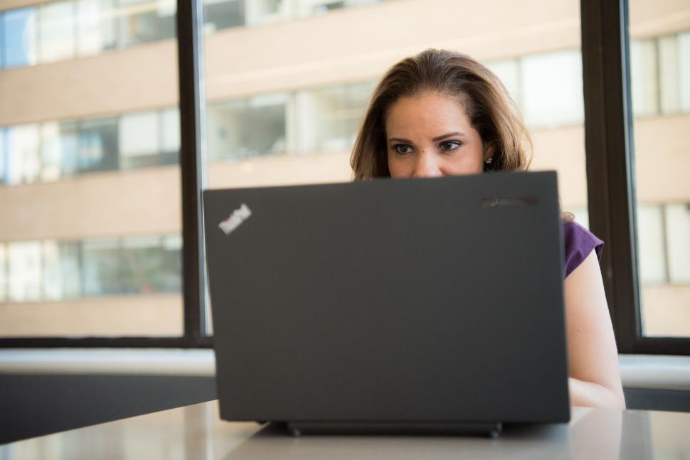 Free Image of Businesswoman with laptop in office - looking at screen 