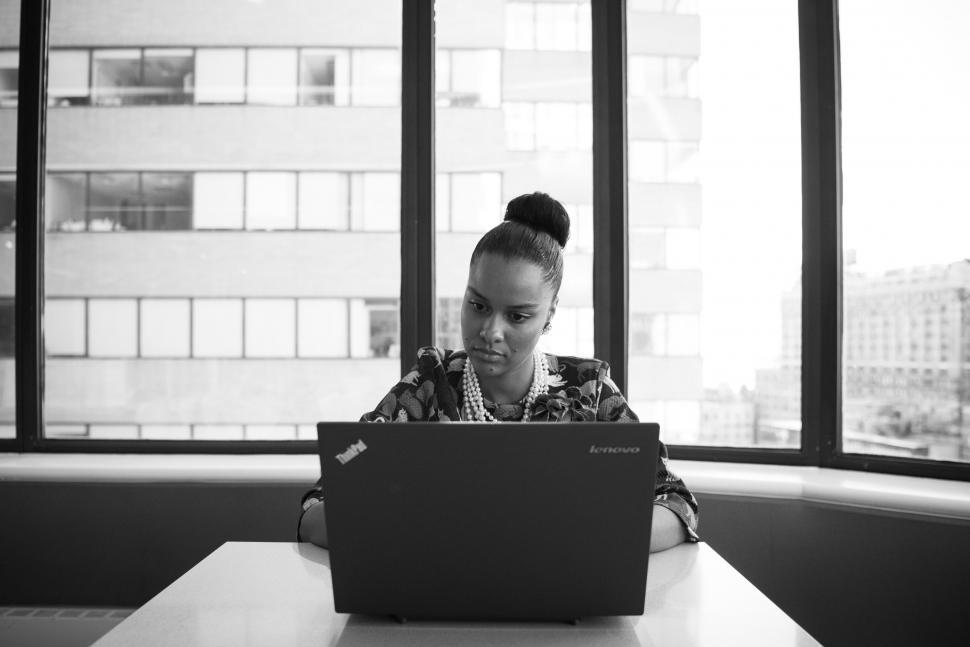 Free Image of Businesswoman with laptop in office - looking at screen 