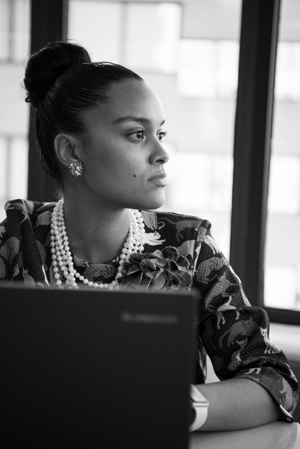 Free Image of Businesswoman with laptop in office - looking away 