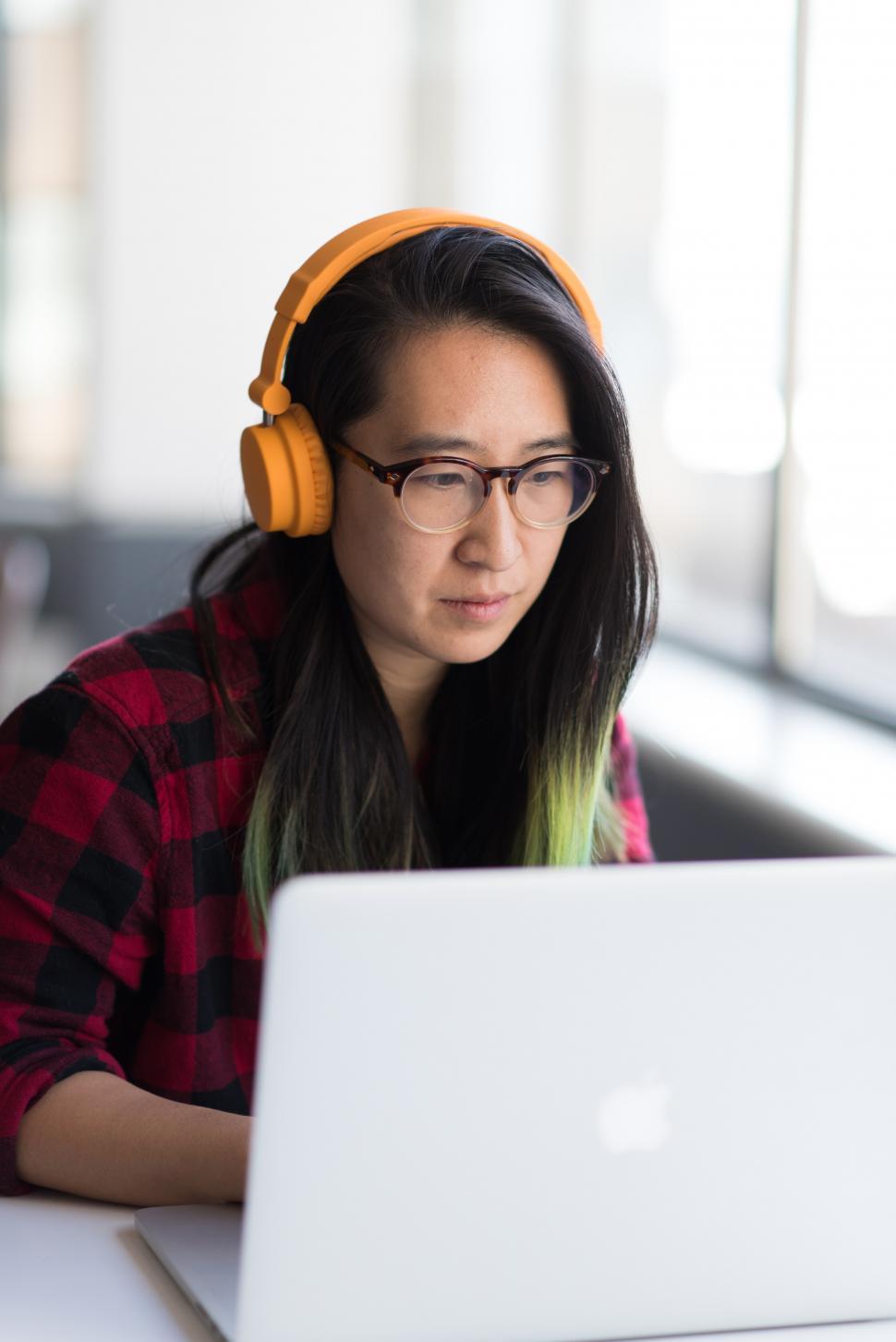 Free Image of Female executive using laptop with headphones 