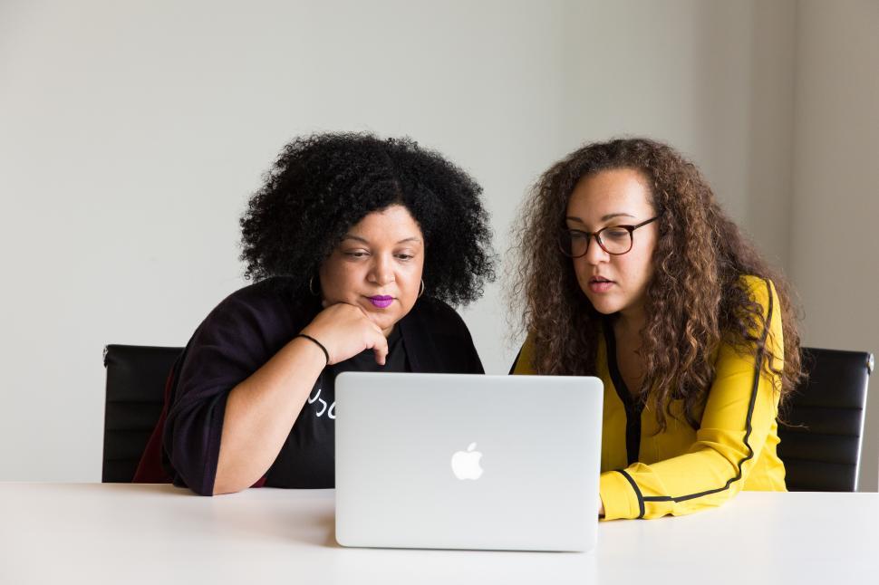 Free Image of Young female co-workers working with laptop 