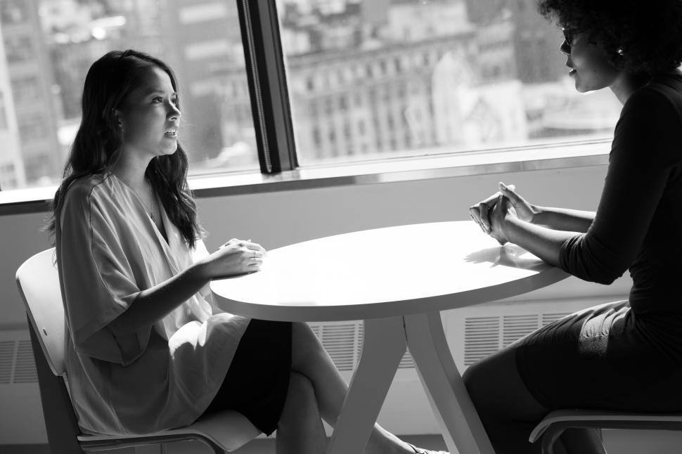 Free Image of Two business women having a conversation - b&w 
